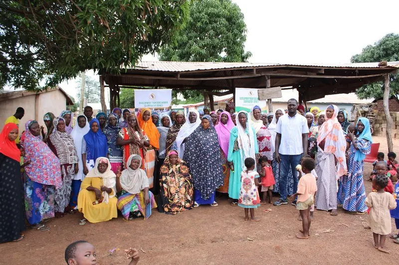 Cooperative members gathered outside a community storage shed