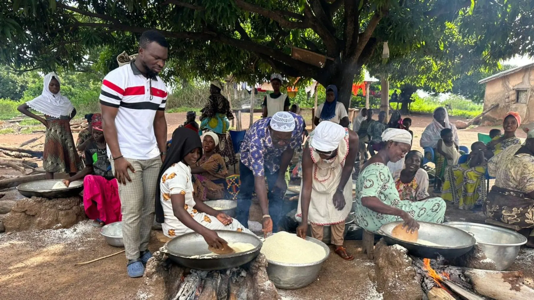 DFWC members processing gari together outdoors