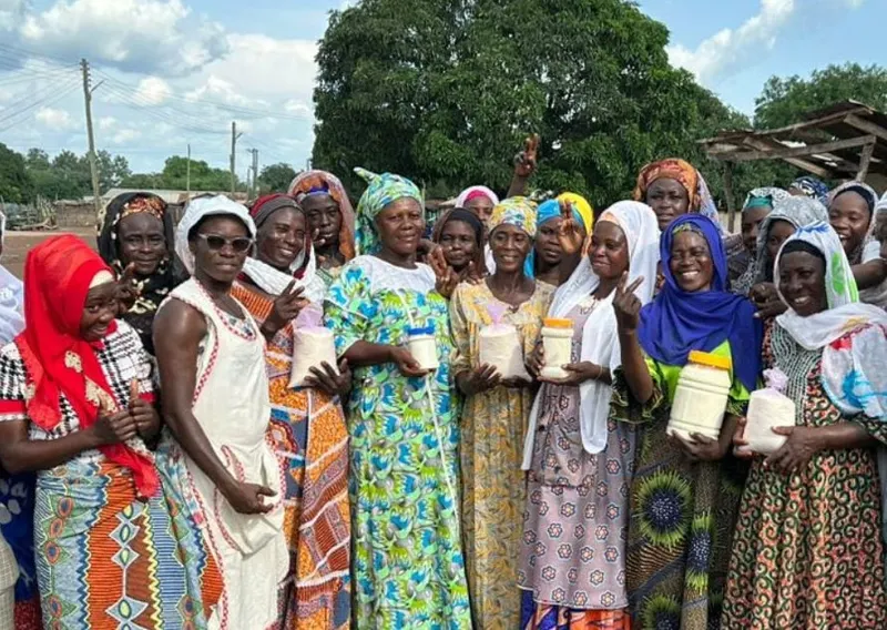 Members holding up products they made to sell